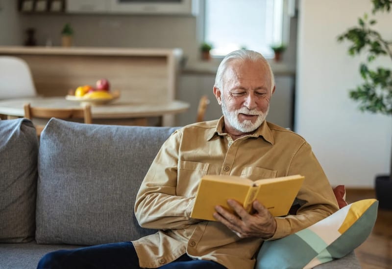Senior reviewing Medicare guide and insurance options